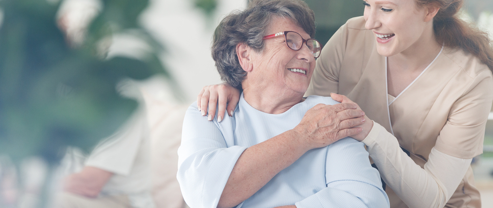 A woman and an older person smiling for the camera.