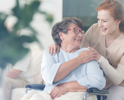 A woman and an older person smiling for the camera.