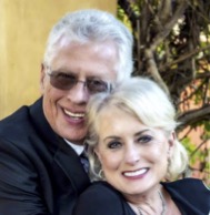 A man and woman posing for the camera. and smiling