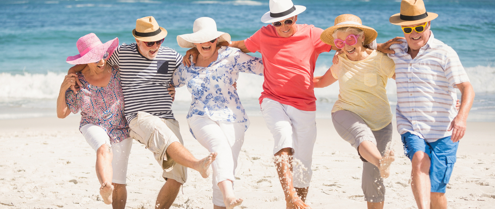 A group of people in hats and white pants on the beach.