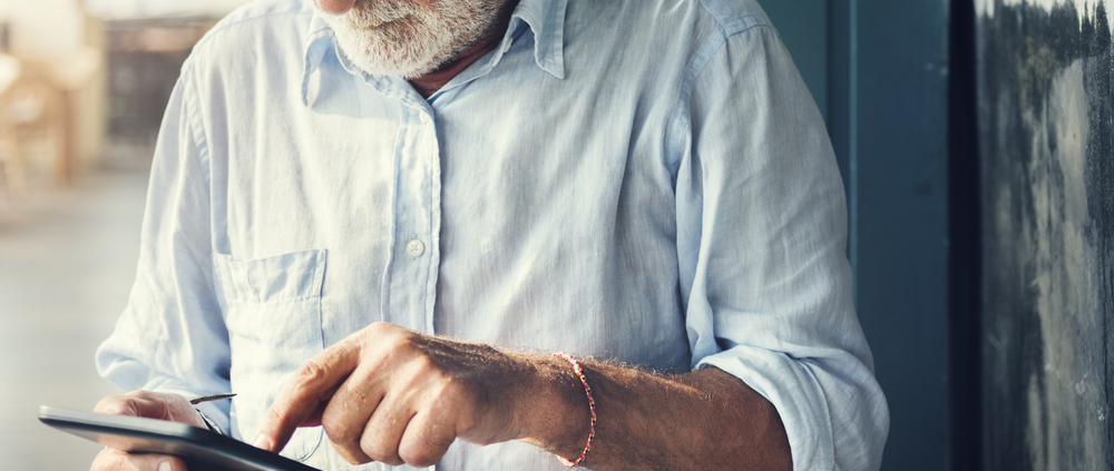 A man in glasses is using his phone