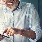 A man in glasses is using his phone