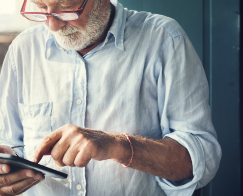 A man in glasses is using his phone